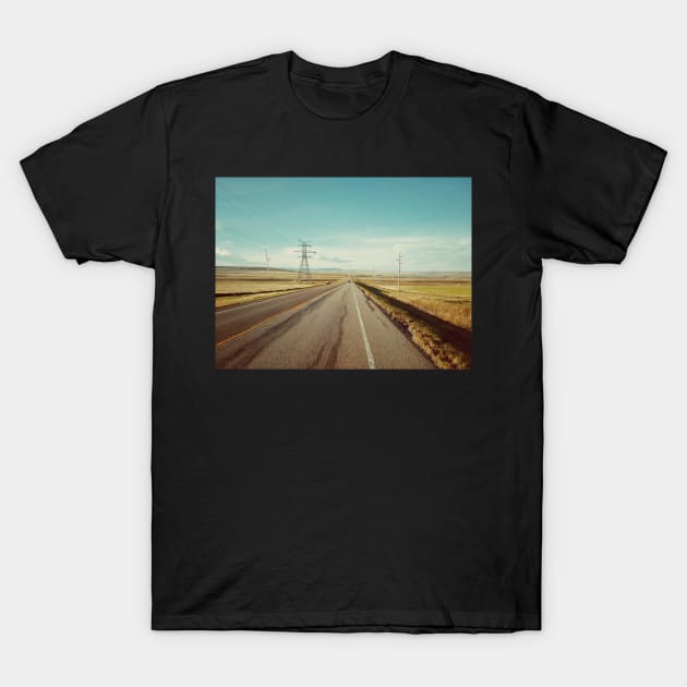 Canadian prairie landscape with a country road near Pincher Creek, Alberta, Canada. T-Shirt by Nalidsa